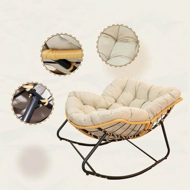 Fauteuil à bascule en rotin tressé gris foncé avec coussins et structure en métal