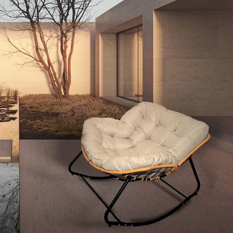 Fauteuil à bascule en rotin tressé gris foncé avec coussins et structure en métal
